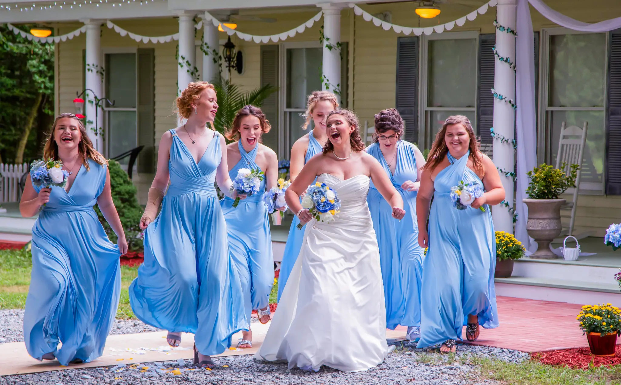 Bride and bridesmaids laughing and walking together