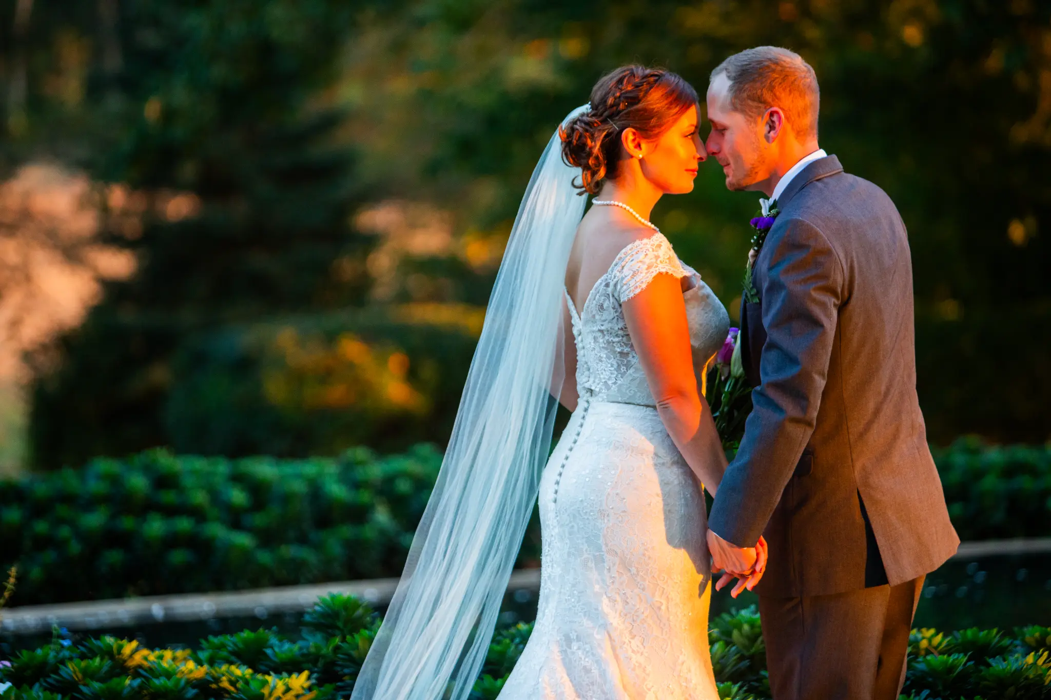 Couple sharing a quiet golden hour moment, foreheads almost touching
